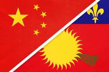 China or PRC vs Guadeloupe national flag from textile. Relationship between asian and american countries.