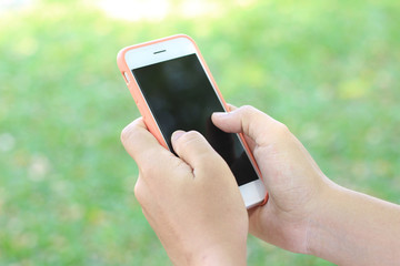 Hand woman holding mobile smart phone at park outdoor.