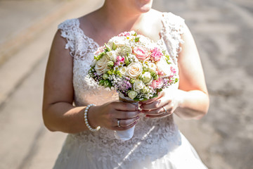 Wedding bouquet of flowers held by bride closeup. Pink flower