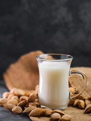 Almond milk . Almonds in a shell on the table