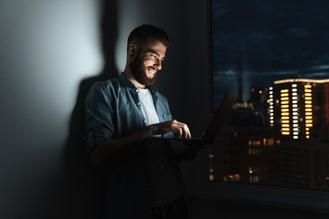 Confident young man working on laptop computer