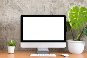 Blank screen of All in one computer, keyboard, mouse, monstera pot and small plant pot on wooden table - obrazy, fototapety, plakaty