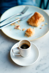 Cup of espresso and blurred breakfast