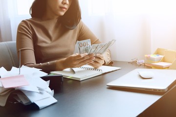 Asian woman is clear, manage for expenses, it's important of account and finance of company. By collect receipt document or slip to record on deadline for correct payment report with Dollars of USA