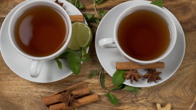A Healthy Cups of Natural Tea For Breakfast with lLime and Mint Cinnamon and Star Anise. Clean Drink, Diet, Detoxification.