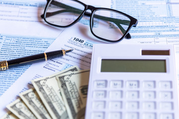 Calculating tax refund or income tax return for saving tax, target for save coin in the piggy bank. Tax and Saving Concept