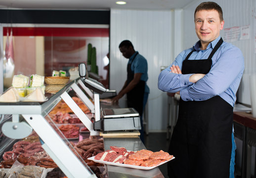 Confident owner of butcher shop