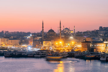 Fototapeta na wymiar Istanbul, Turkey - Jan 14, 2020: New Mosque (Yeni Cami) at night with Hagia Sophia (Aya Sofya) behind seen across the Golden Horn, Istanbul, Turkey, Europe