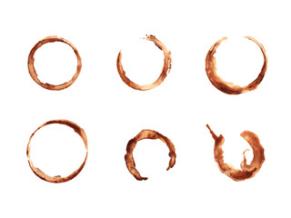Set of traces of cup of coffee isolated on white background. Round coffee blots. Round frame made of spilled coffee. Elements for the design of business cards or flyers of coffee shop.