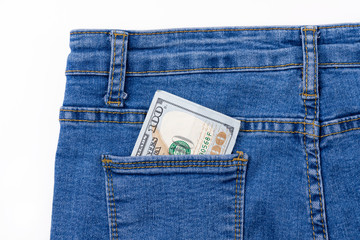 One hundred dollar banknote money in pocket jeans pants background texture. 100 dollar bill close up