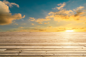 Fototapeta na wymiar Empty wooden board square and sunset yellow sky