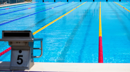 Empty swimming pool with competition lanes for background.