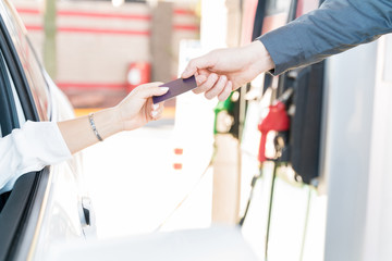 Attendant Receiving Credit Card From Woman