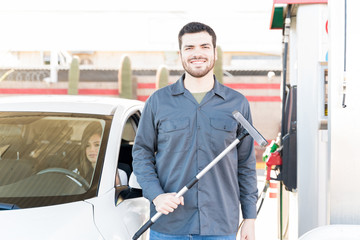 Smiling Attendant Working At Gas Station