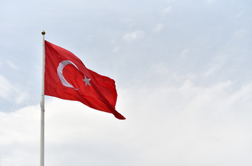 Large flag of Republic of Turkey on sky background