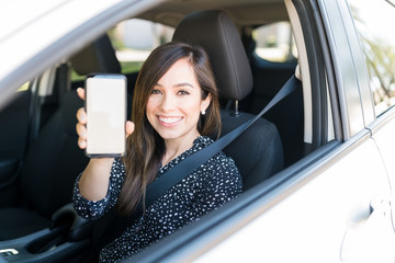 Smiling Beautiful Woman With Cellphone In Car