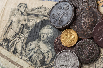 Gold and silver coins of the Russian Empire19 - 20 century in the background kopyur.Five rubles Nicholas II.Concept Russian antiques.Saint George cross of Imperial Russia.Antikvariat.
