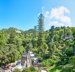 Fototapeta na wymiar Portugal. Sintra. Quinta da Regaleira. Panorama of the territory. Bower below, chapel spire on the right, Moors Castle at the top