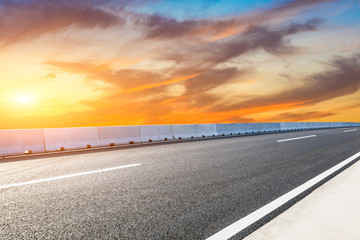 Fototapeta premium Empty asphalt road and sunset sky landscape in summer