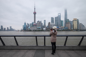 The unspecific girl at the Shanghai Waitan "The Bund" at the viewpoint.