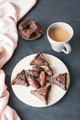 Chocolate hamantaschen cookies with coconut on baking tray for Jewish holiday Purim. Dairy free, egg free, gluten free.