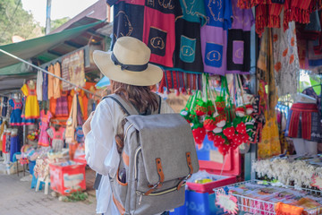 Smiling woman traveler in doi suthep temple chiangmai landmark in thailand with backpack on holiday, relaxation concept, travel concept