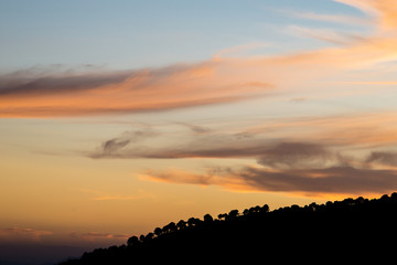 Obraz premium Sunset with clouds and silhouettes of trees in southern Spain.