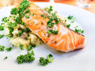 grilled salmon and lemon - french cuisine dish with tomato and salmon