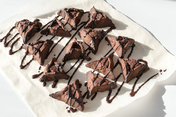 Chocolate hamantaschen cookies with coconut on baking tray for Jewish holiday Purim. Dairy free,...