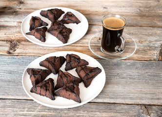 Chocolate hamantaschen cookies with coconut on baking tray for Jewish holiday Purim. Dairy free, egg free, gluten free.