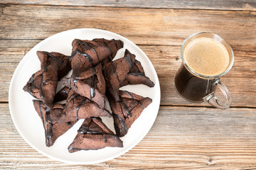 Chocolate hamantaschen cookies with coconut on baking tray for Jewish holiday Purim. Dairy free, egg free, gluten free.