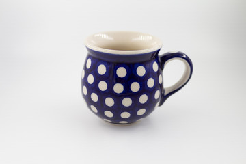 white and blue ceramic cup