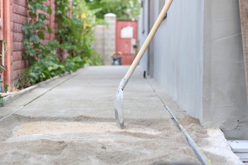 Laying gray concrete paving slabs