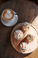 Cupcakes with hearts, coffee shop, romantic meeting for St. Valentine.