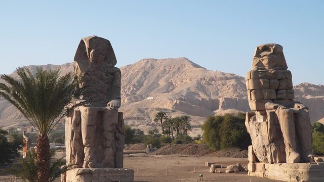 Egypt art. The Colossi of Memnon are two massive stone statues of the Pharaoh Amenhotep III, who reigned in Egypt during the Dynasty XVIII.