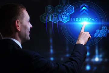 Business, Technology, Internet and network concept. Young businessman working on a virtual screen of the future and sees the inscription: Industry 4.0