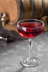 Bitter Sweet Cocktail with Gin, Campari, Berry Syrup and olive on grey table