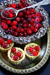 Still life with cranberry cakes on a blue background