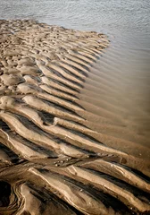 Fotobehang Ripples of sand on the beach after flow © Fran