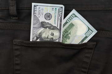 One hundred dollar banknote money in pocket trouser pants background texture. dollar bill close up