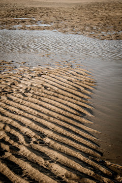 Ripples of sand on the beach after flow