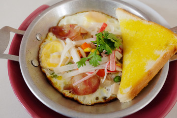 Indochina pan-fried egg with toppings in homemade and Butter Toast easy breakfast in Thailand