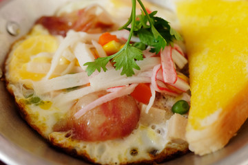 Indochina pan-fried egg with toppings in homemade and Butter Toast easy breakfast in Thailand