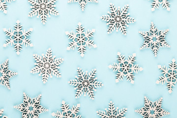 Christmas background. White snow decorations on a pink background.
