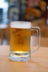 Beer in glass on wooden table