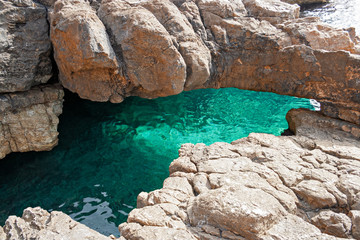 Beautiful cave among the rocks on the coast of the island of Levanzo in Sicily, Italy.