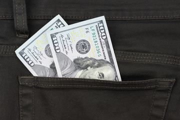 One hundred dollar banknote money in pocket trouser pants background texture. dollar bill close up