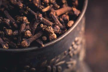 Dry cloves spices on the dark rustic background. Selective focus. shallow depth of field.