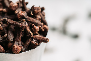 Dry cloves spices on the dark rustic background. Selective focus. shallow depth of field.