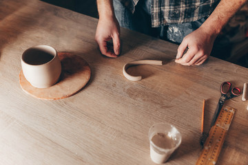 Potter creates the details for the ceramic cup